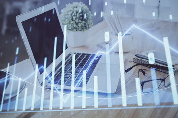 Forex Chart hologram on table with computer background. Multi exposure. Concept of financial markets.