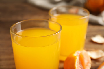 Fototapeta premium Glass of fresh tangerine juice, closeup view