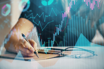 Multi exposure of woman's hands making notes with forex graph hologram. Concept of technical...
