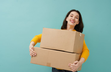 woman is holding cardboard box
