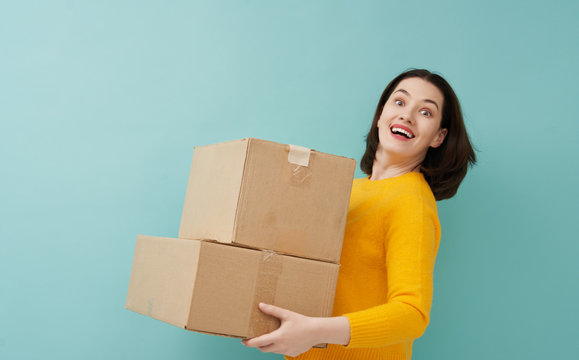 woman is holding cardboard box