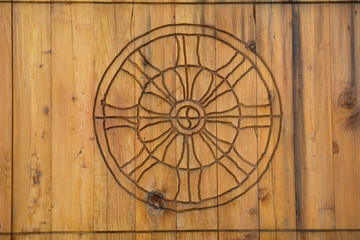Fototapeta na wymiar Dharma Wheel Buddhist symbol in door