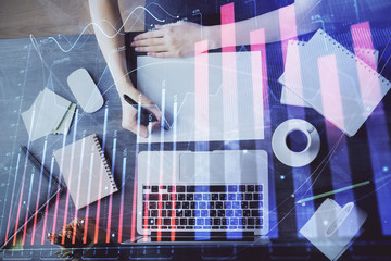 Financial graph displayed on woman's hand taking notes background. Concept of research. Multi exposure