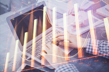 Double exposure of forex chart with man working on computer on background. Concept of market analysis.