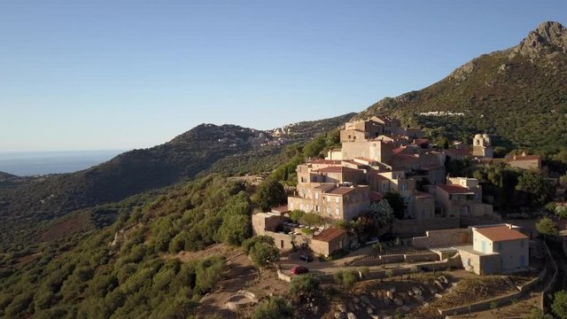 Aerial drone forward flight footage in the afternoon time of Pigna village in the Corse island near Ile la Rousse, France.