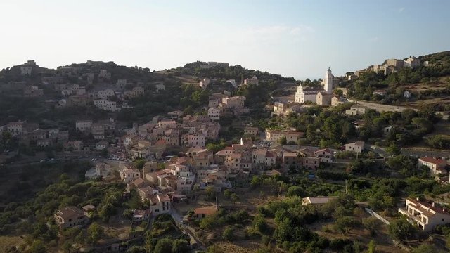 Aerial drone forward flight footage in the afternoon time of Corbara village in the Corse island near Ile la Rousse, France.