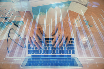Double exposure of market chart with man working on computer on background. Concept of financial...