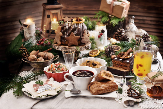 Christmas Eve Table With Traditional Dishes And Cakes