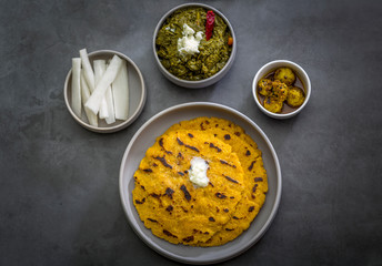 Makki ki roti with sarson ka saag, popular north indian main course menu usually prepared in winter season, using cornmeal breads and mustard leaves vegetables
