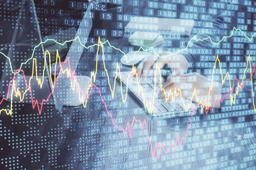 Double exposure of financial graph with man works in office on background. Concept of analysis.