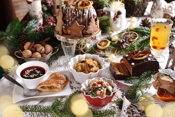Fototapeta Christmas Eve table with traditional dishes and cakes obraz