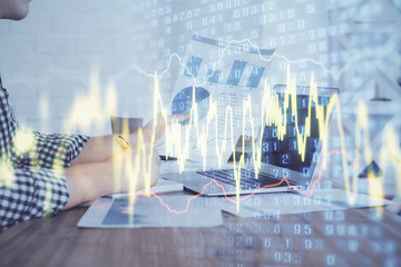 Multi exposure of financial graph with man works in office on background. Concept of analysis.