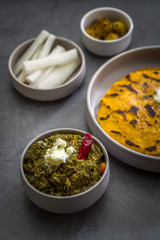 Makki ki roti with sarson ka saag, popular north indian main course menu usually prepared in winter season, using cornmeal breads and mustard leaves vegetables