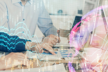 Multi exposure of chart with man typing on computer in office on background. Concept of hard work.