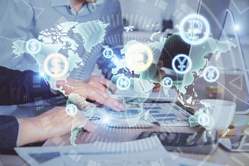 Multi exposure of chart with man typing on computer in office on background. Concept of hard work.