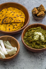 Makki ki roti with sarson ka saag, popular north indian main course menu usually prepared in winter season, using cornmeal breads and mustard leaves vegetables