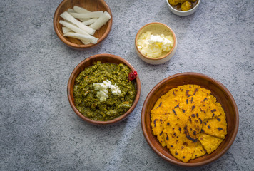Makki ki roti with sarson ka saag, popular north indian main course menu usually prepared in winter season, using cornmeal breads and mustard leaves vegetables