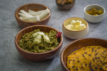 Makki ki roti with sarson ka saag, popular north indian main course menu usually prepared in winter season, using cornmeal breads and mustard leaves vegetables
