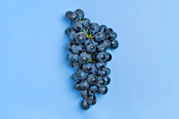 Natural organic black juicy grapes on a trend classic blue background  Top View Flat Lay. Rustic...