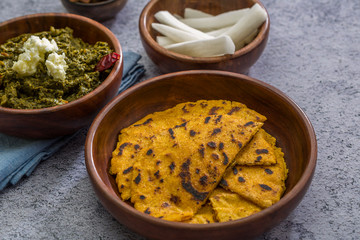 Makki ki roti with sarson ka saag, popular north indian main course menu usually prepared in winter season, using cornmeal breads and mustard leaves vegetables