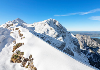 View to the summit of a snow-covered mountain in the Ammergau Alps. Bavaria, Germany