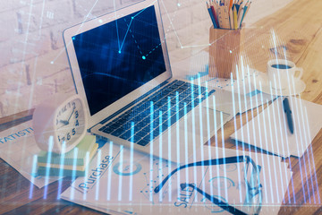 Double exposure of chart and financial info and work space with computer background. Concept of international online trading.