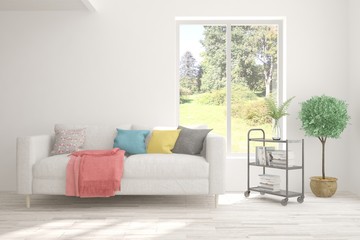 Stylish room in white color with sofa and summer landscape in window. Scandinavian interior design. 3D illustration