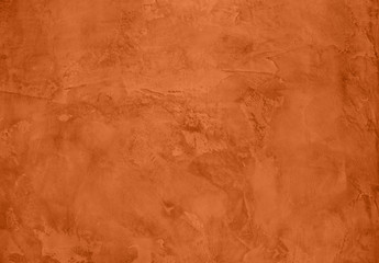 Saturated orange colored low contrast Concrete textured background with roughness and irregularities. 2020 color trend.