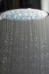 Naklejka na ściany i meble Shower head and falling water.