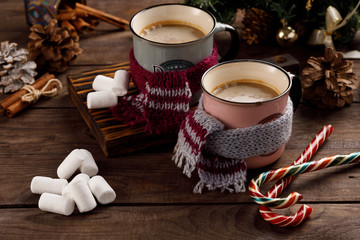 Christmas marshmallows and New Year decorations and sweet canes on a wooden background. Winter holidays, new year mood. Copy space. Close up.