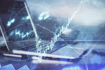 Forex market chart hologram and personal computer background. Multi exposure. Concept of investment.