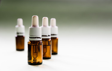 cosmetology, skin care, a row of glass bottles with pipettes and hyaluronic acid inside on a light...