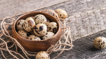 Quail eggs in wooden bowl.  Diet and healthy food