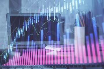 Stock market graph on background with desk and personal computer. Double exposure. Concept of financial analysis.