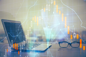 Stock market chart hologram drawn on personal computer background. Double exposure. Concept of investment.
