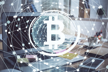 Multi exposure of blockchain theme hologram and table with computer background. Concept of bitcoin crypto currency.