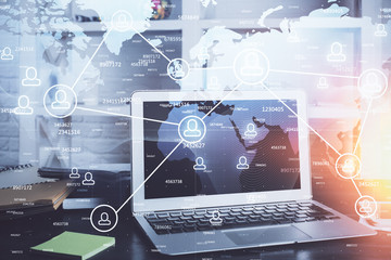 Computer on desktop with social network theme icon. Multi exposure. Concept of international connections.