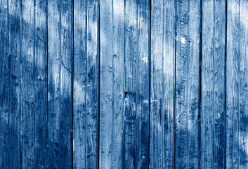 Fototapeta na wymiar close up view of old grunge wood panels toned in trendy Classic Blue color of the Year 2020