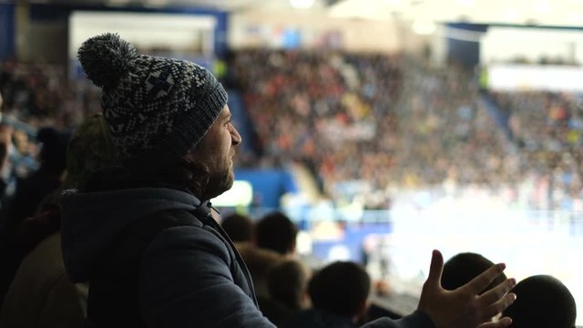 Guys expressive support hockey fan in crowd closeup gesture. People spectator emotion cheering cold hockey close up fan watch sports match 4K. Male team cheering emotion crowded stadium leisure man.