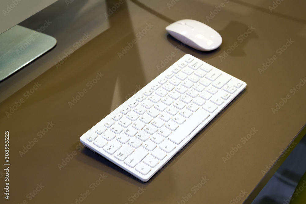 Aufkleber close up view of beige desk with white keyboard and mouse next to display