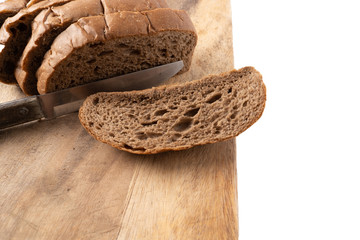 Sliced bread on a wooden chopping board isolated on white