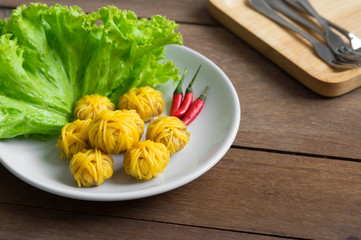 Thai traditional fried pork ball with noodles .