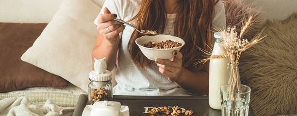 Healthy organic nutrition. Woman enjoying breakfast with oatmeal in bed, free space. 