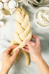 Making traditional jewish challah bread on marble background, copy space