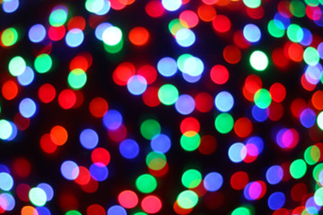 Defocused Christmas background with colorful bokeh lights.