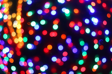 Defocused Christmas background with colorful bokeh lights.
