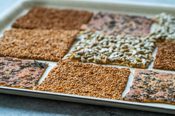 Turkish Homemade Snacks Biscuit with Sunflower Seeds, Sesame and Dill /Crispy Yaprak Galeta with Traditional Tea on Tray.