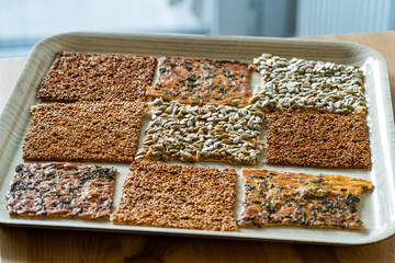 Turkish Homemade Snacks Biscuit with Sunflower Seeds, Sesame and Dill /Crispy Yaprak Galeta with Traditional Tea on Tray.