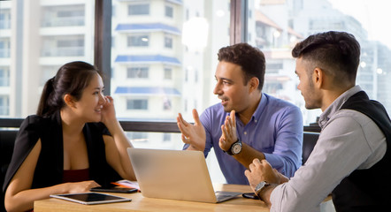 Working together on project. Two young business colleagues working on computer