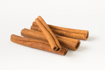 Cinnamon sticks aromatic condiment on white.